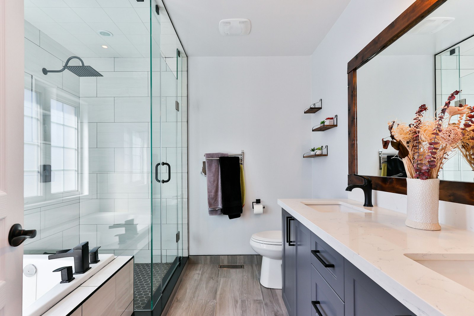 The finished bathroom with glass shower and double vanity