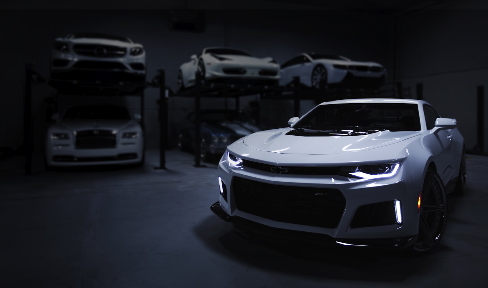 Cars staged on lifts inside the shop